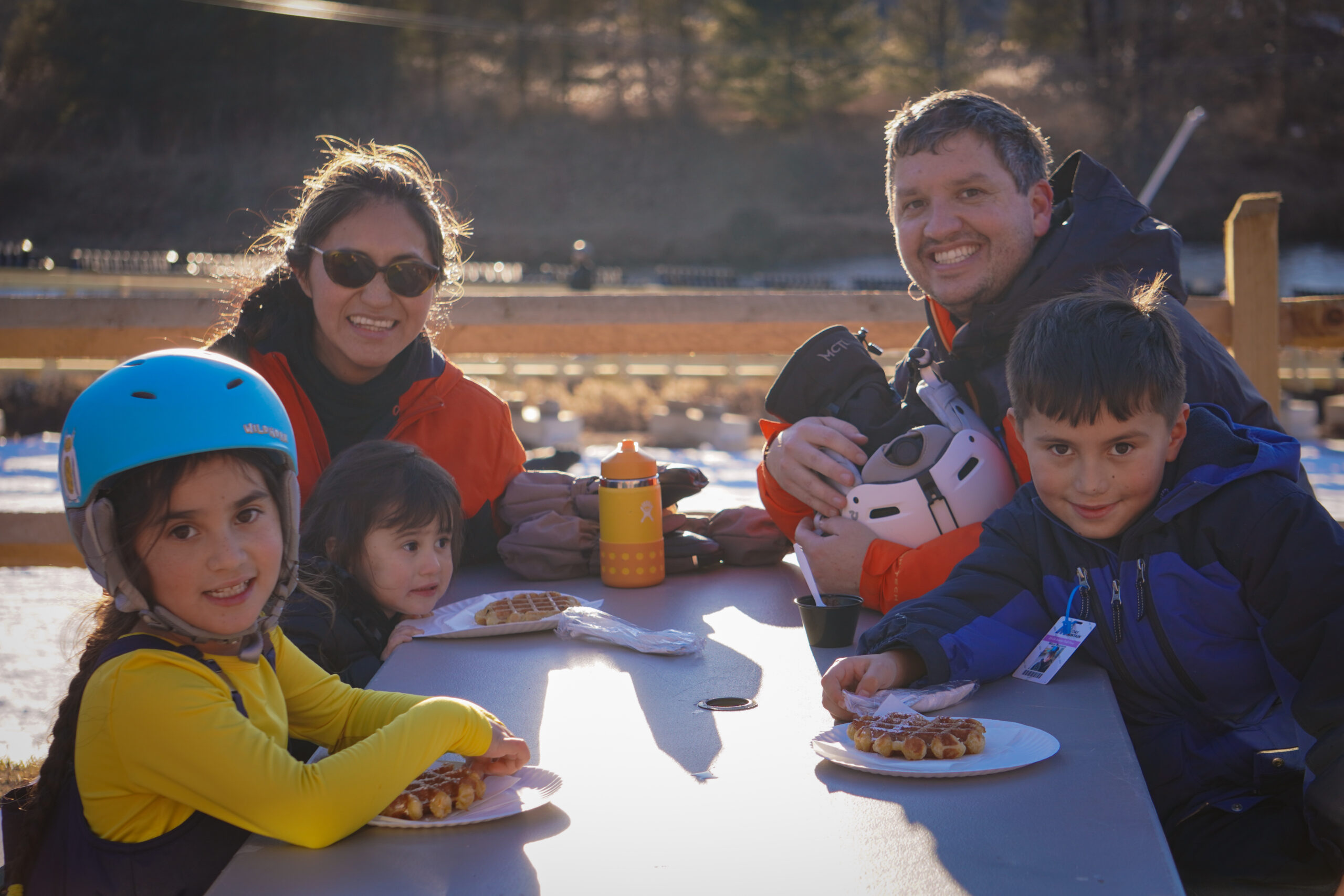 Family of four eating waffles together