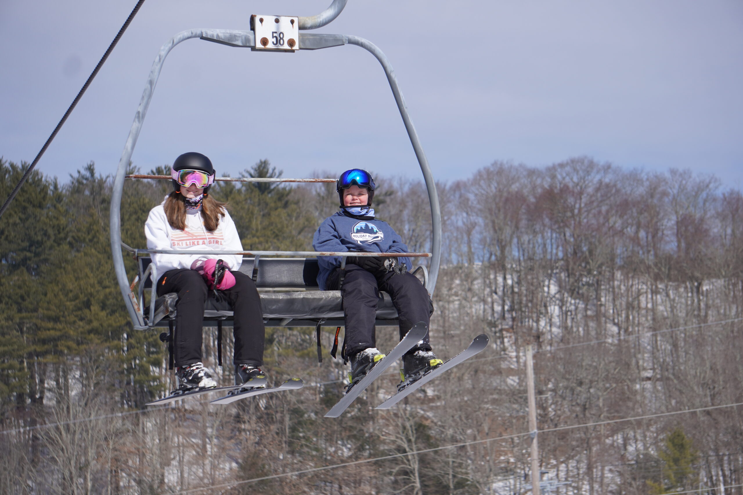 Two kids smiling on a lift