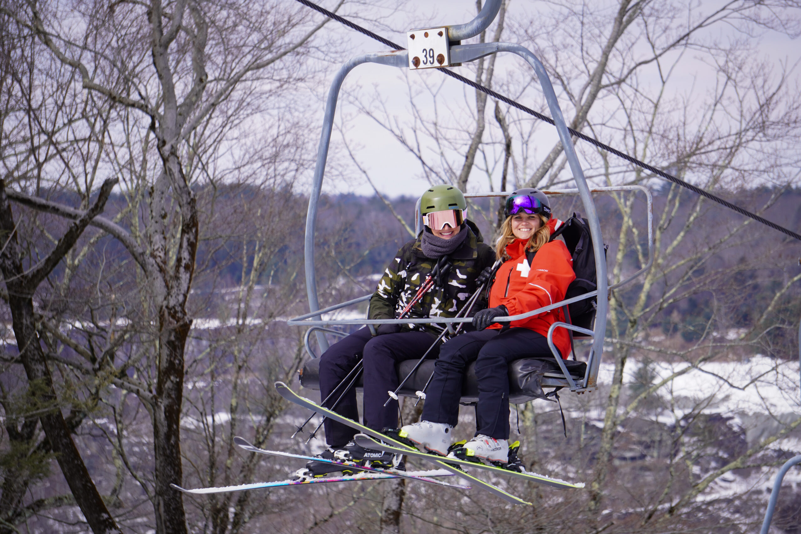 Skiers smiling on a chairlift