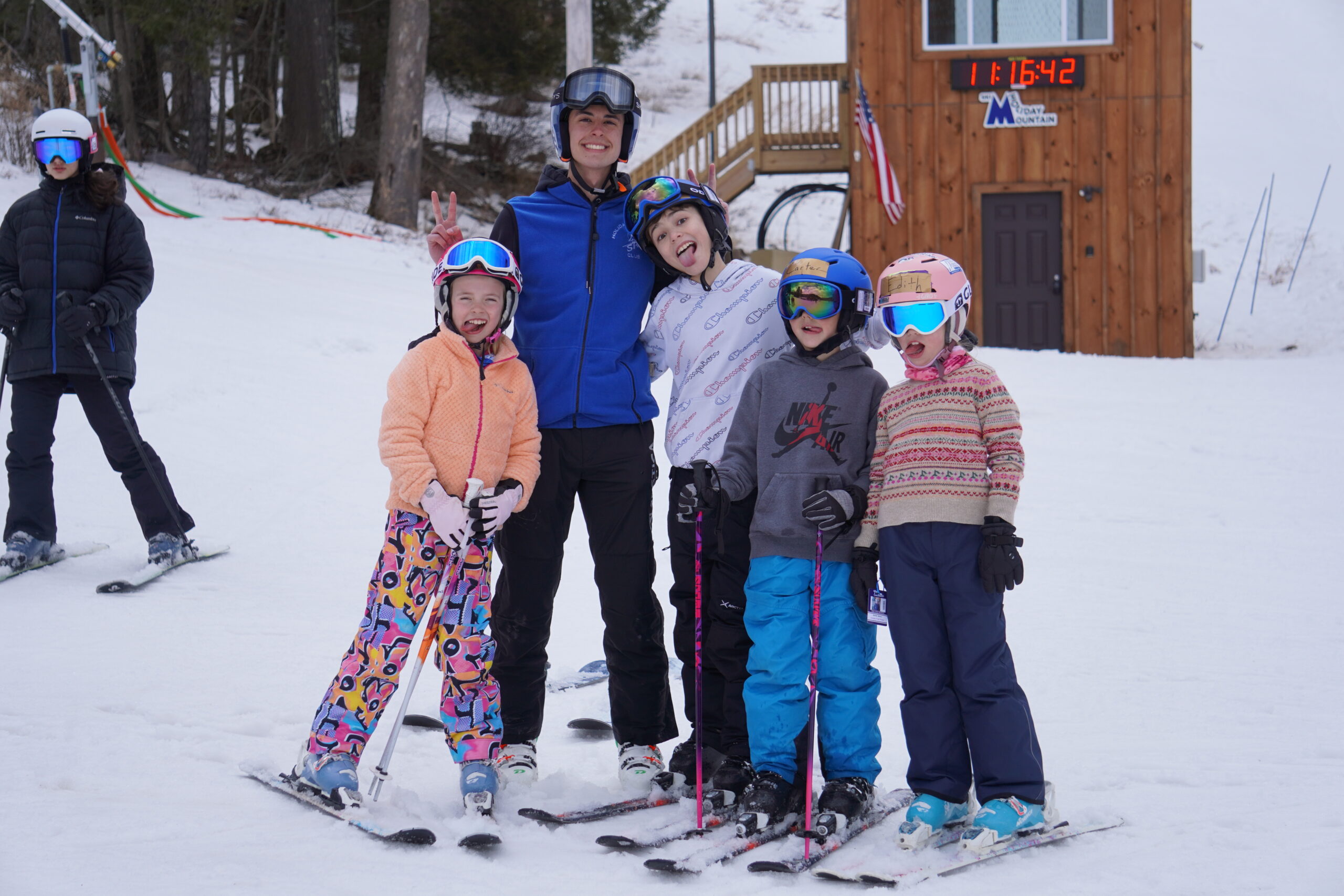 a group of kids posing for a photo on skis